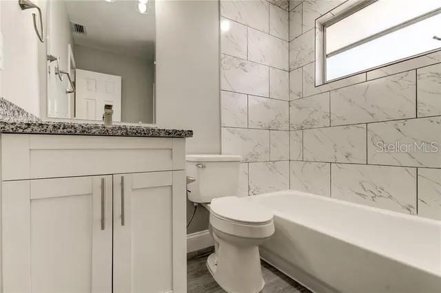 300 6th Street North, Unit W2 Safety Harbor, FL 34695 - Photo 19 of 22 a bathroom with a toilet sink and bathtub