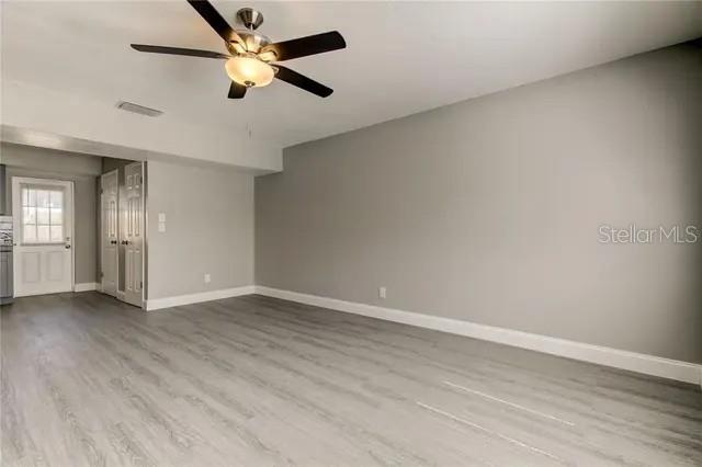 300 6th Street North, Unit W2 Safety Harbor, FL 34695 - Photo 3 of 22 an empty room with wooden floor and windows