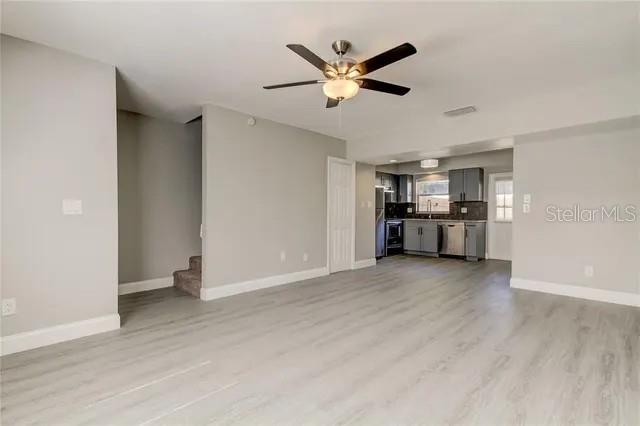 300 6th Street North, Unit W2 Safety Harbor, FL 34695 - Photo 4 of 22 a view of a big room with wooden floor and a ceiling fan