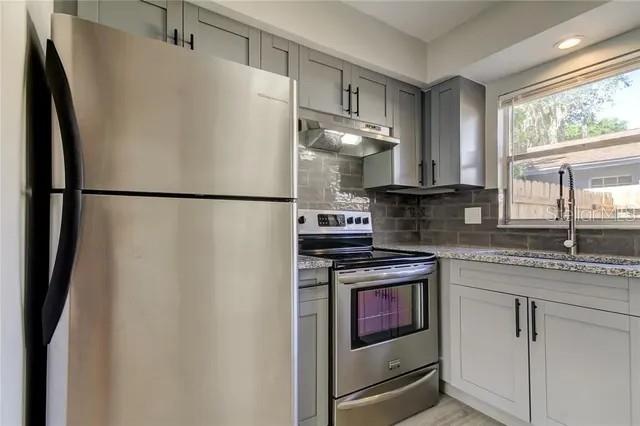 300 6th Street North, Unit W2 Safety Harbor, FL 34695 - Photo 6 of 22 a white refrigerator freezer sitting inside of a kitchen