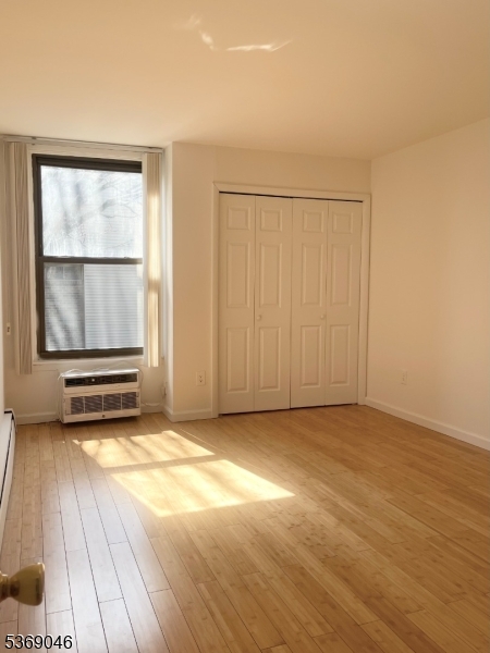 21 River Road, Unit G Nutley, NJ 07110 - Photo 4 of 22 an empty room with wooden floor and windows