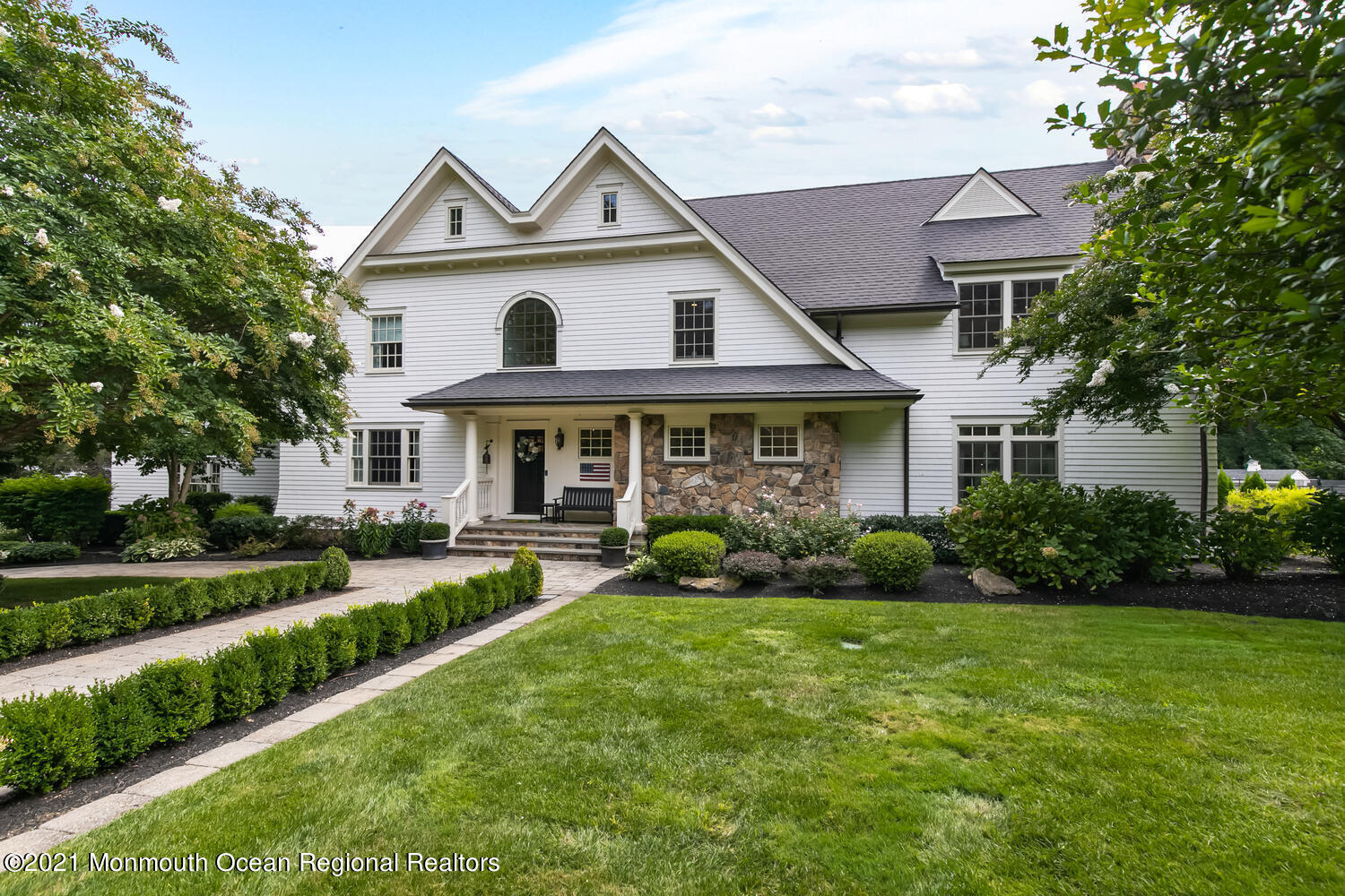 a front view of a house with a yard and porch