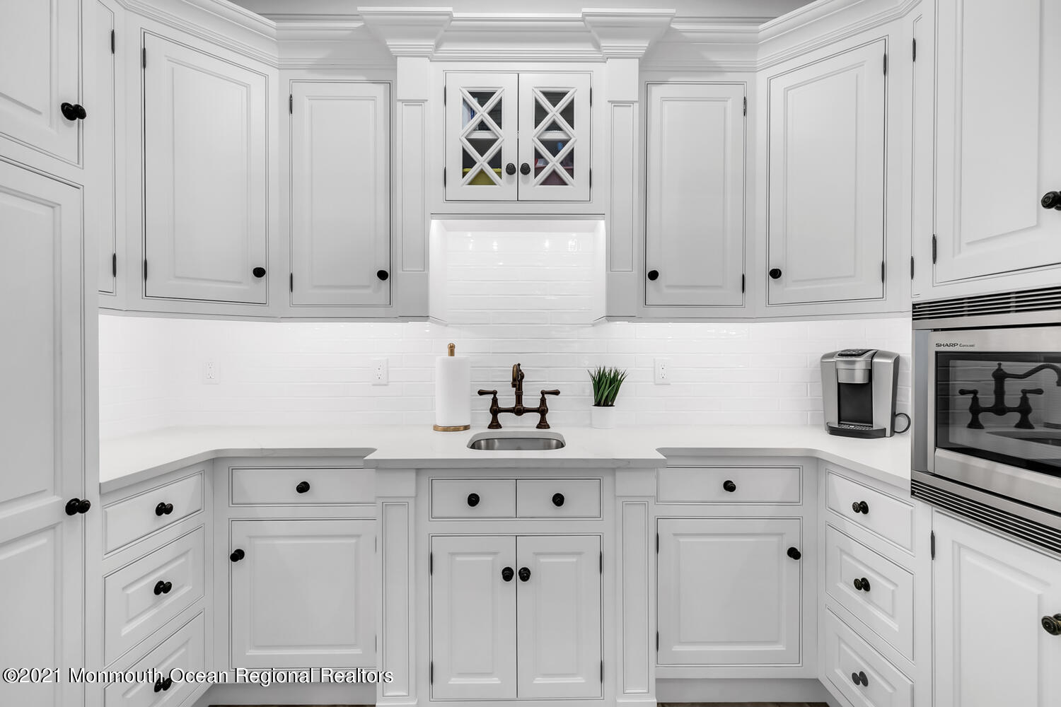 7 Sheraton Lane Rumson, NJ 07760 - Photo 11 of 32 a kitchen with white cabinets and black appliances