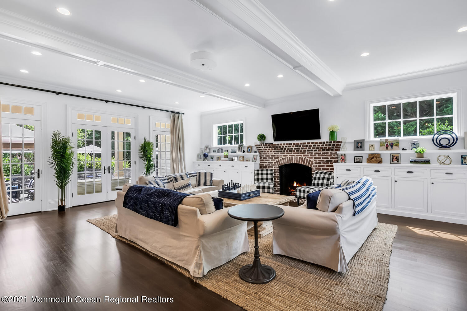 7 Sheraton Lane Rumson, NJ 07760 - Photo 3 of 32 a living room with furniture a large window and a fireplace
