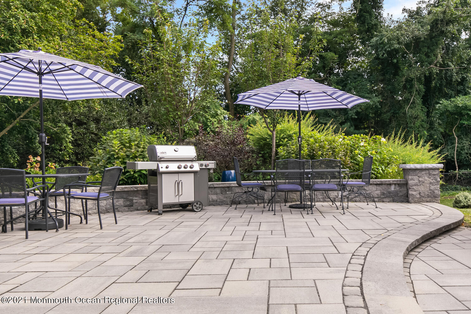 7 Sheraton Lane Rumson, NJ 07760 - Photo 28 of 32 a view of a patio with a table and chairs under an umbrella