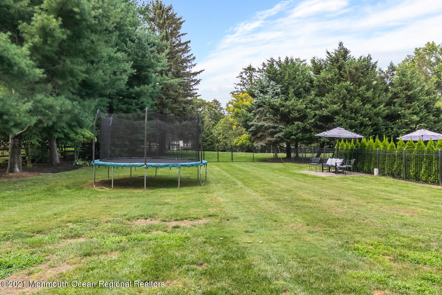 7 Sheraton Lane Rumson, NJ 07760 - Photo 30 of 32 a backyard of a house with yard and trampoline