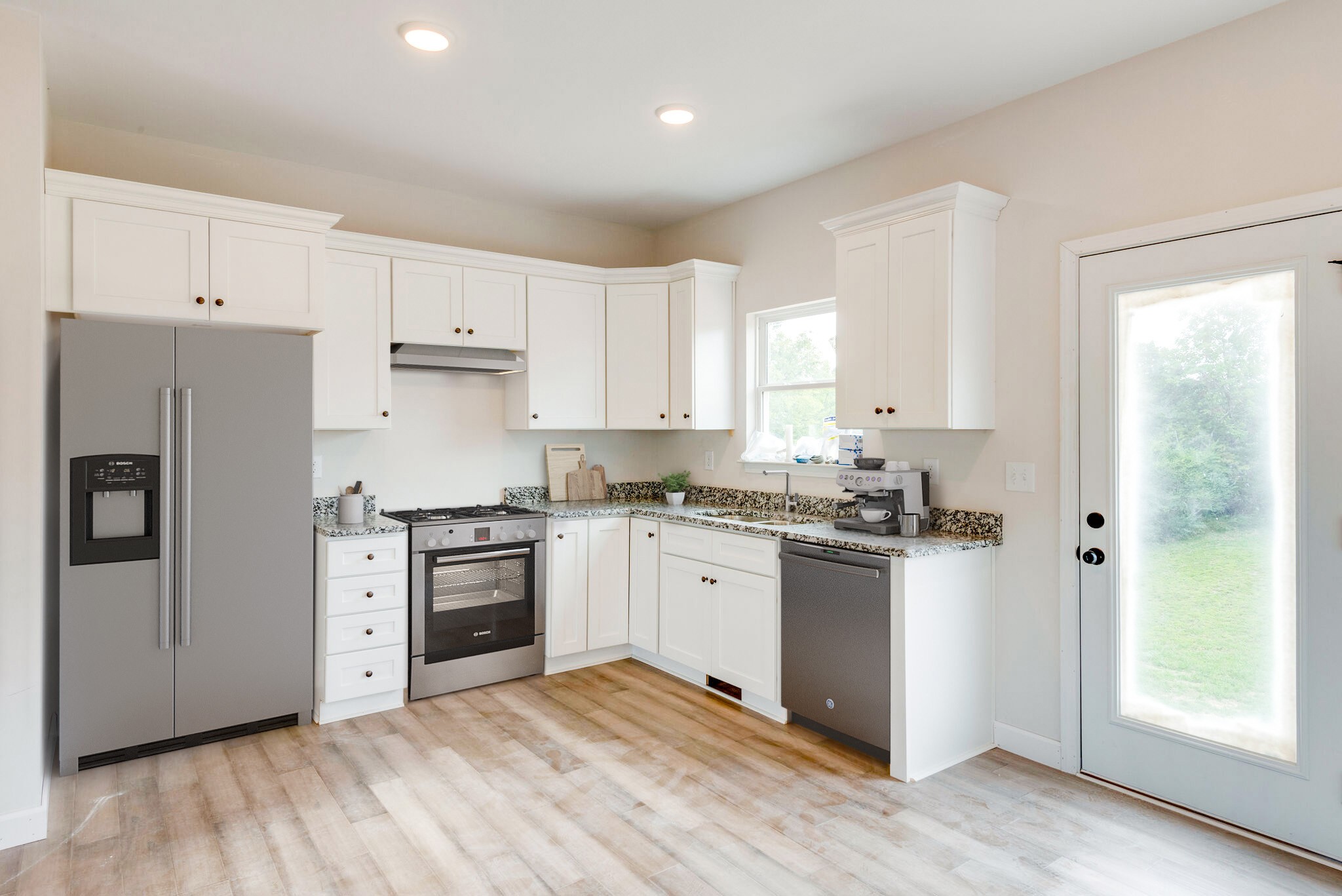 1282 Oak Grove Road Dickson, TN 37055 - Photo 13 of 29 a kitchen with granite countertop white cabinets and stainless steel appliances