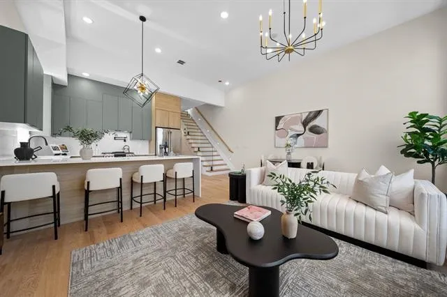 a living room with furniture potted plant and a chandelier