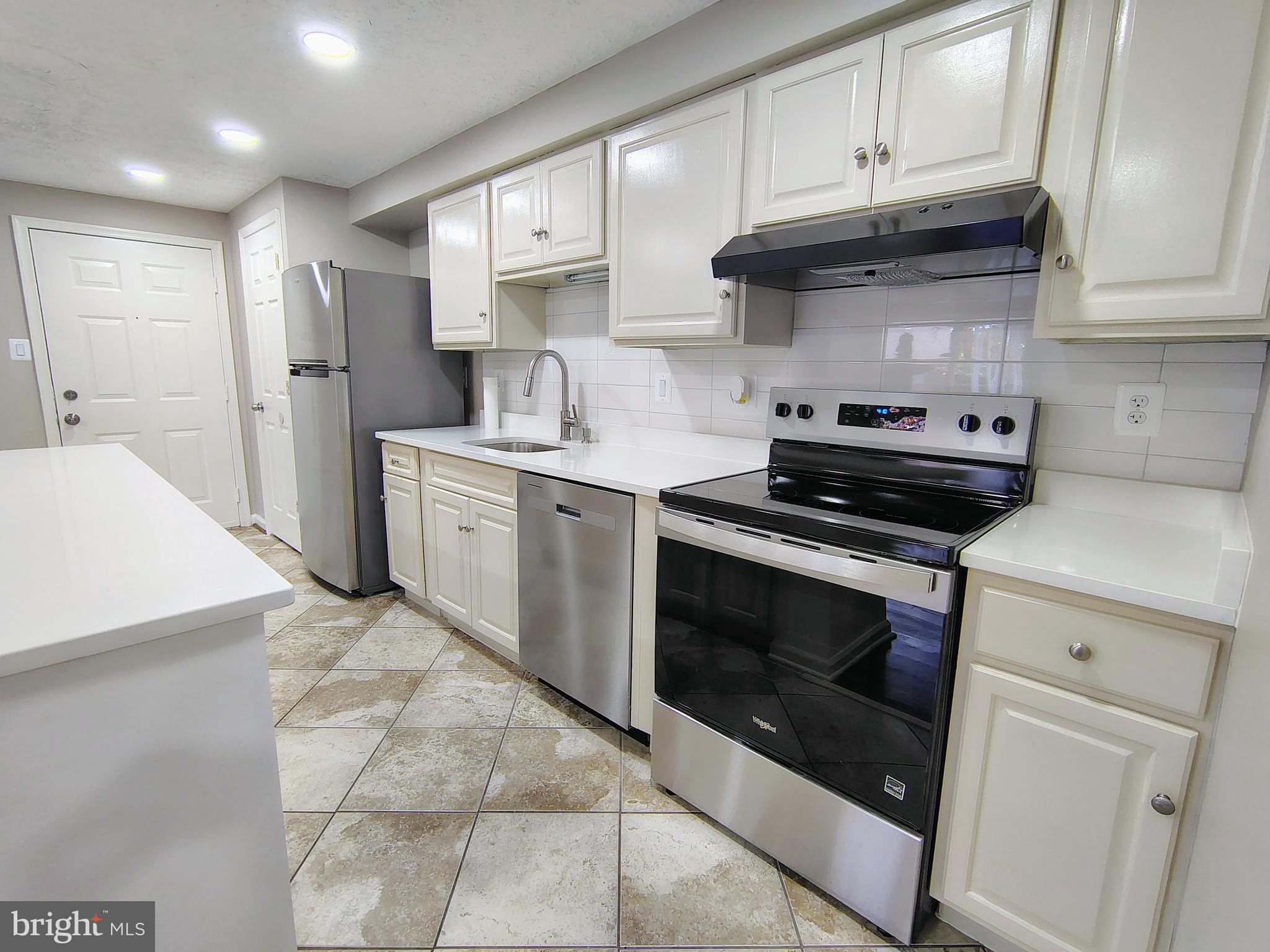 12407 Hickory Tree Way, Unit 524 Germantown, MD 20874 - Photo 1 of 21 a kitchen with stainless steel appliances granite countertop a stove and a refrigerator