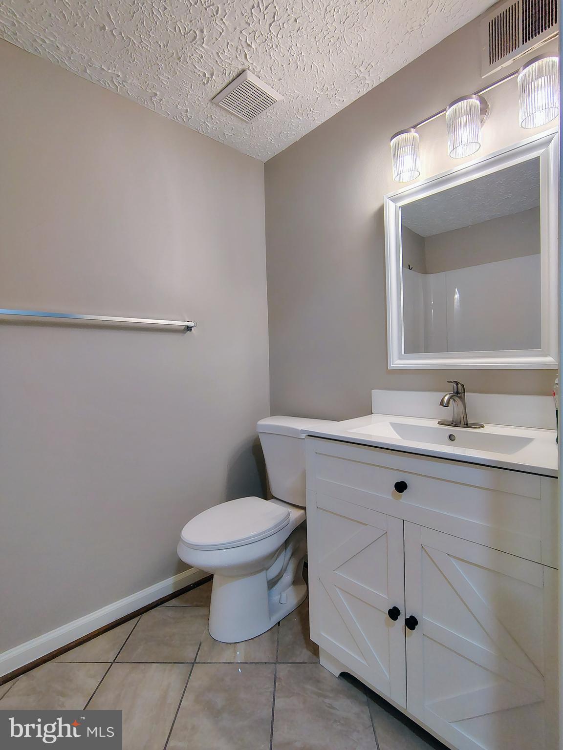 12407 Hickory Tree Way, Unit 524 Germantown, MD 20874 - Photo 11 of 21 a bathroom with a sink toilet and a mirror
