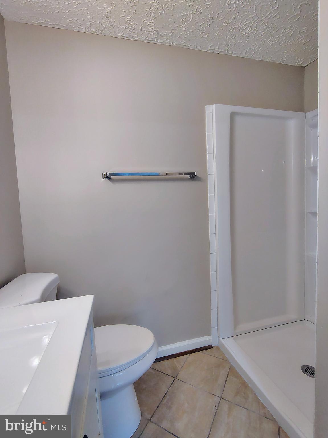 12407 Hickory Tree Way, Unit 524 Germantown, MD 20874 - Photo 19 of 21 a bathroom with a toilet and a shower