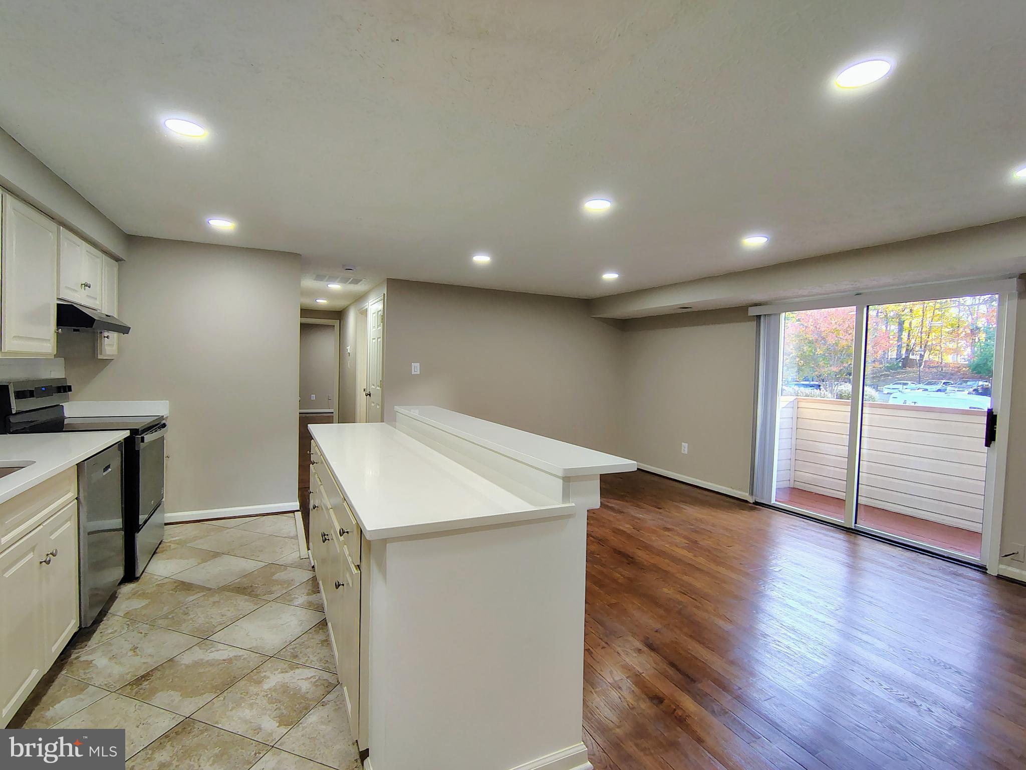 12407 Hickory Tree Way, Unit 524 Germantown, MD 20874 - Photo 8 of 21 a view of a kitchen center island with wooden floor