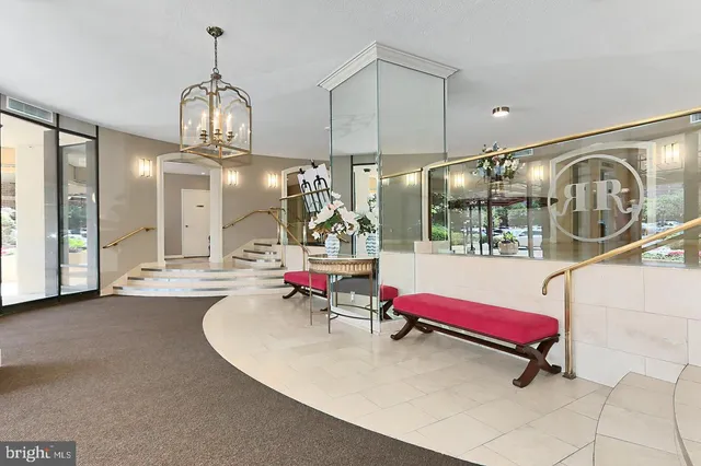 a lobby with chandelier and living room