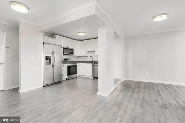 a view of kitchen with wooden floor and electronic appliances