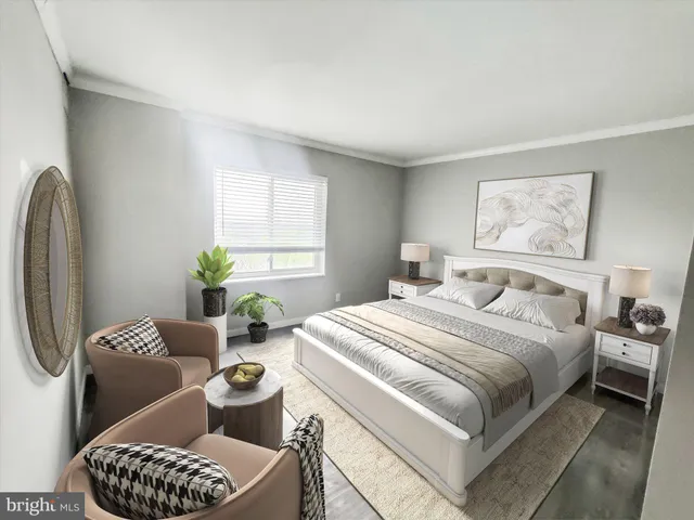 a bedroom with a bed a couch and a potted plant