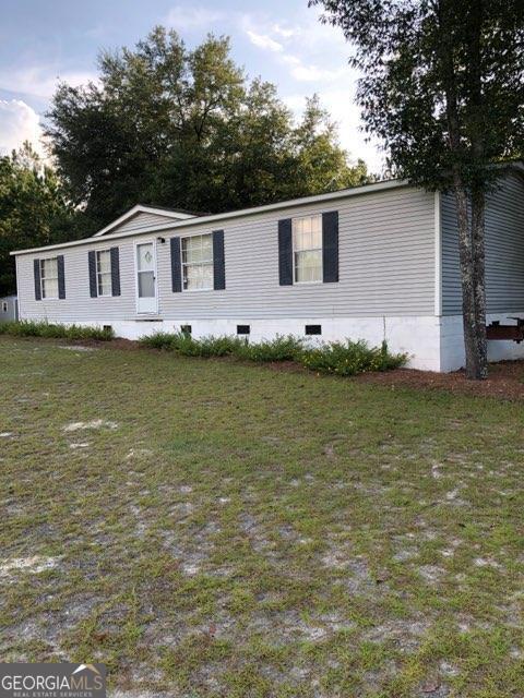 3047 Ben Carter Road Baxley, GA 31513 - Photo 1 of 1 a front view of a house with garden