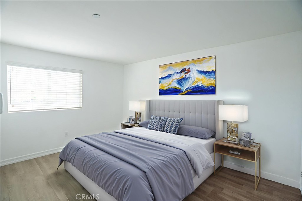1401 Lomita Boulevard, Unit 302 Harbor City, CA 90710 - Photo 11 of 29 a bedroom with a bed and painting on the wall