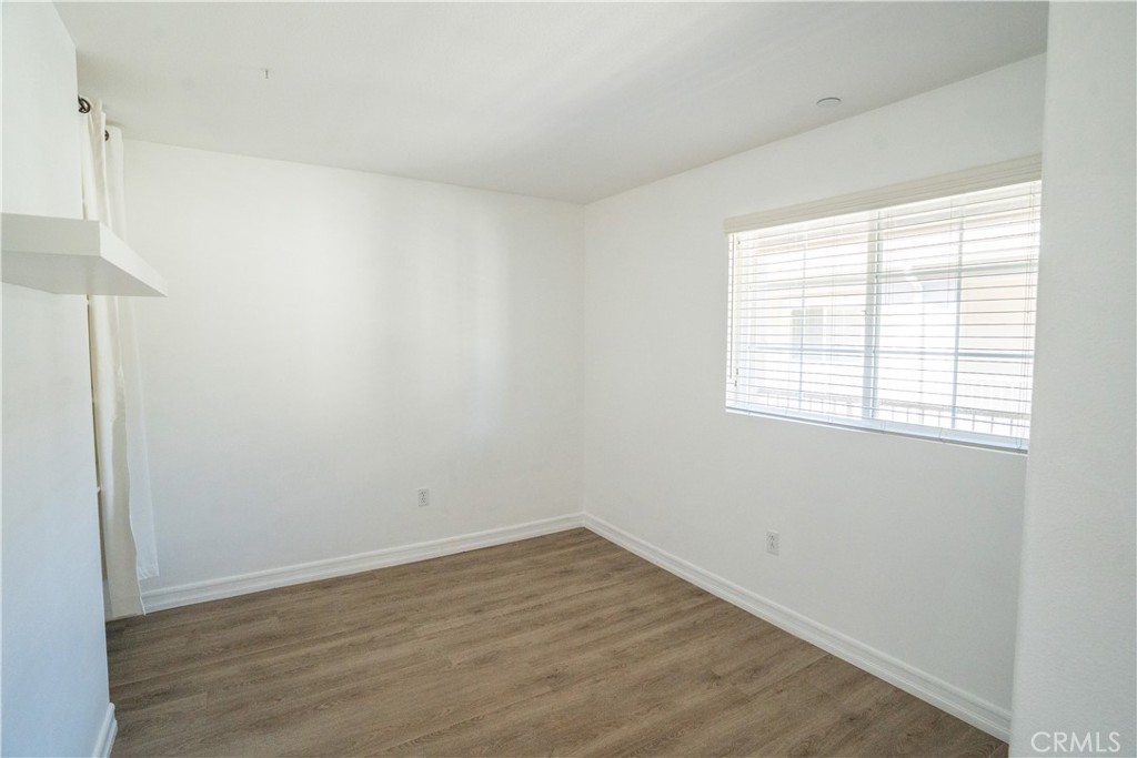 1401 Lomita Boulevard, Unit 302 Harbor City, CA 90710 - Photo 16 of 29 an empty room with wooden floor and windows