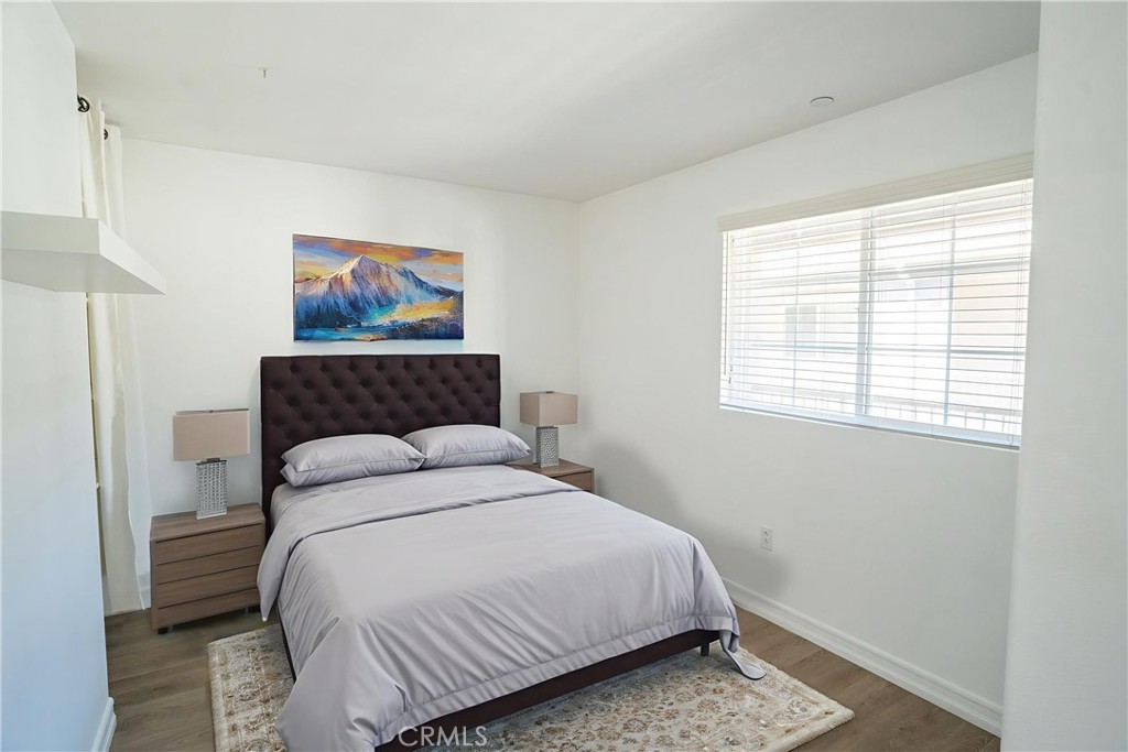 1401 Lomita Boulevard, Unit 302 Harbor City, CA 90710 - Photo 17 of 29 a bedroom with a bed and a painting on the wall