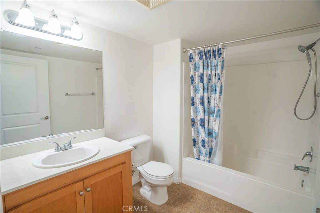 1401 Lomita Boulevard, Unit 302 Harbor City, CA 90710 - Photo 19 of 29 a bathroom with a sink a toilet and shower