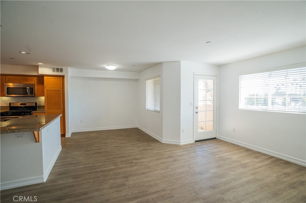 1401 Lomita Boulevard, Unit 302 Harbor City, CA 90710 - Photo 5 of 29 a view of a kitchen with a sink and dishwasher wooden floor
