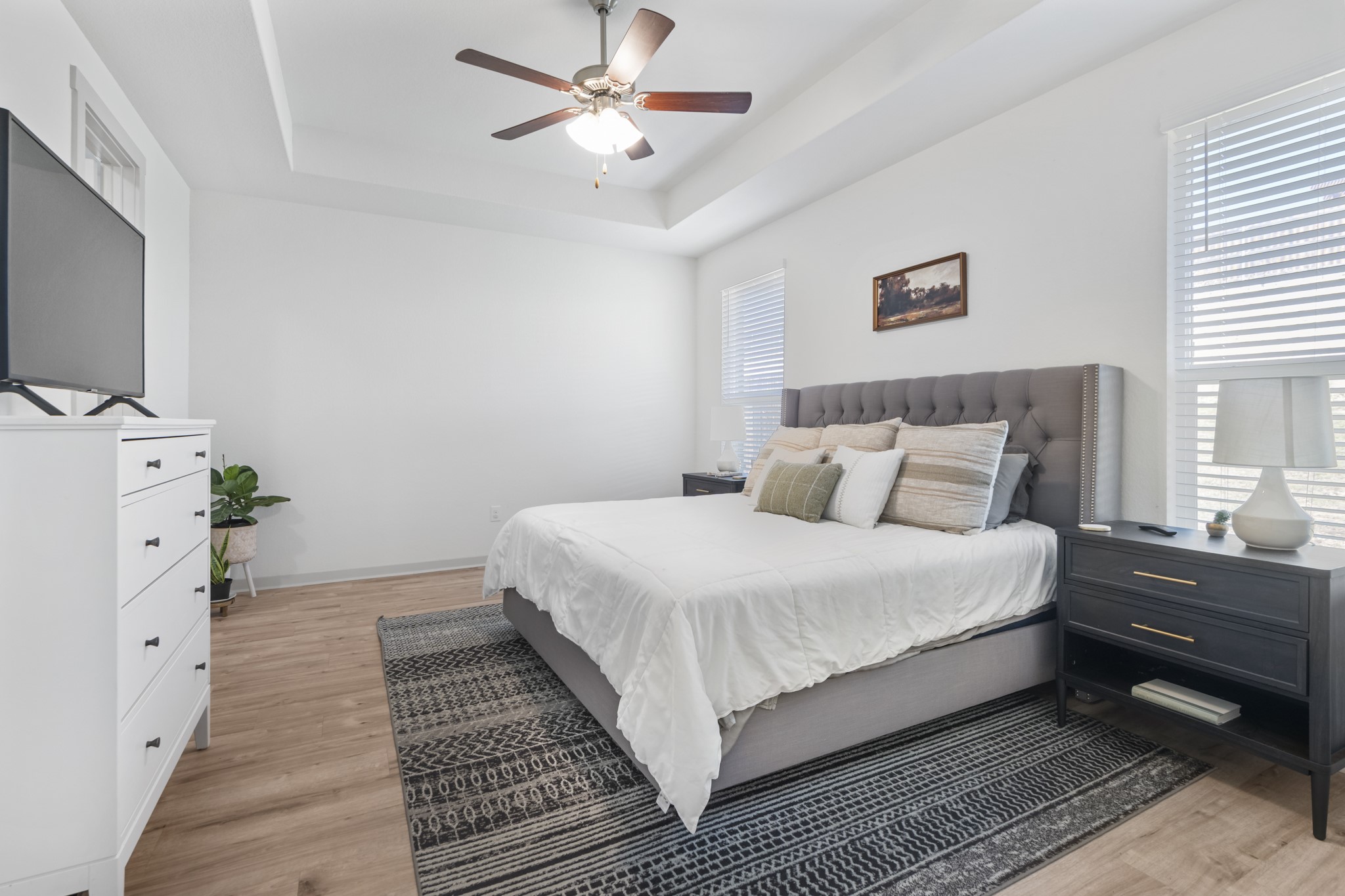 620 Peace Pipe Way Georgetown, TX 78628 - Photo 15 of 32 a bedroom with a bed and a flat tv screen on dresser
