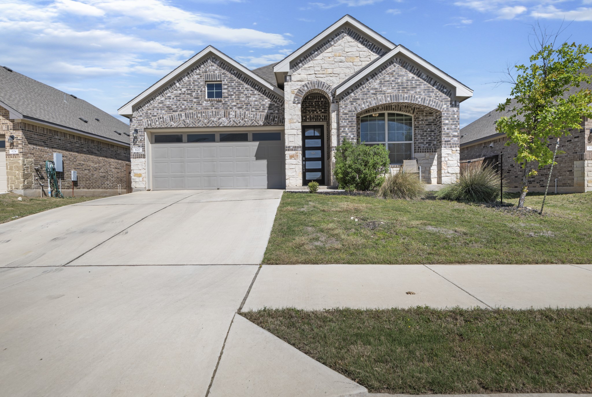 620 Peace Pipe Way Georgetown, TX 78628 - Photo 2 of 32 a front view of a house with a yard