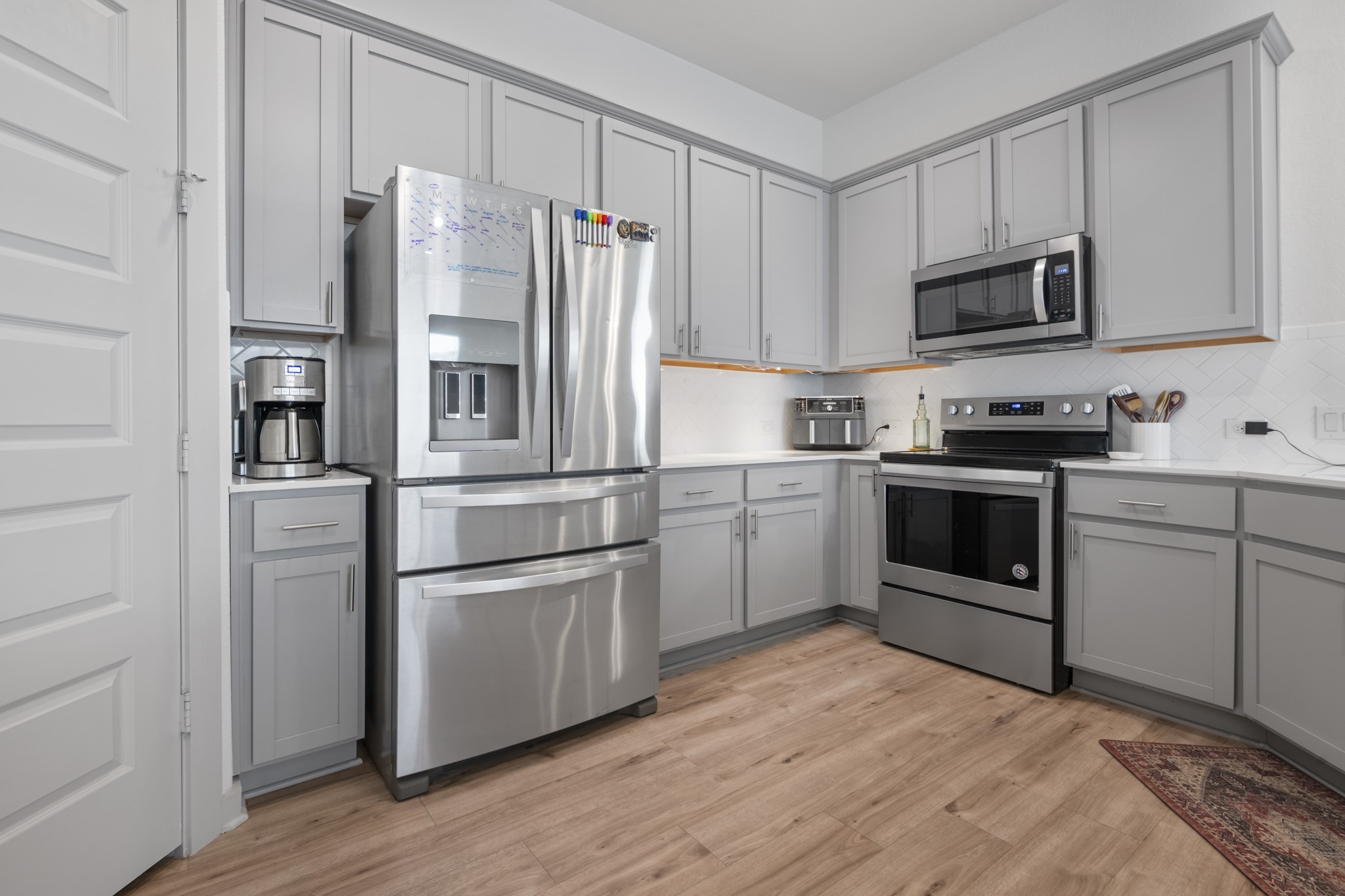 620 Peace Pipe Way Georgetown, TX 78628 - Photo 22 of 32 a kitchen with stainless steel appliances a refrigerator stove and microwave