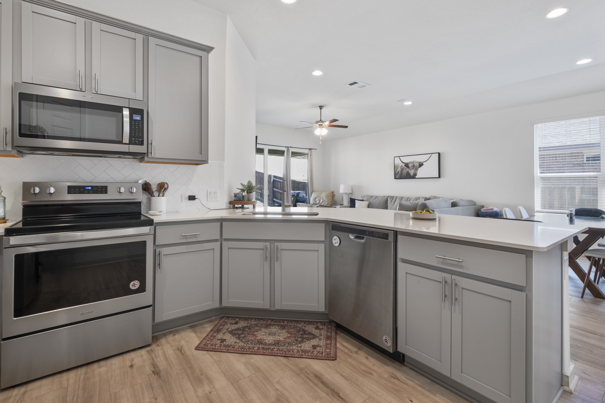 620 Peace Pipe Way Georgetown, TX 78628 - Photo 23 of 32 a kitchen with a sink stove and microwave