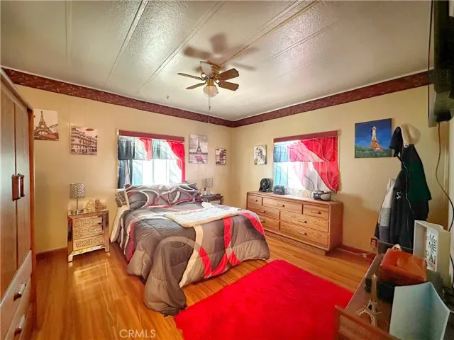 a bed room with a bed and a flat tv screen