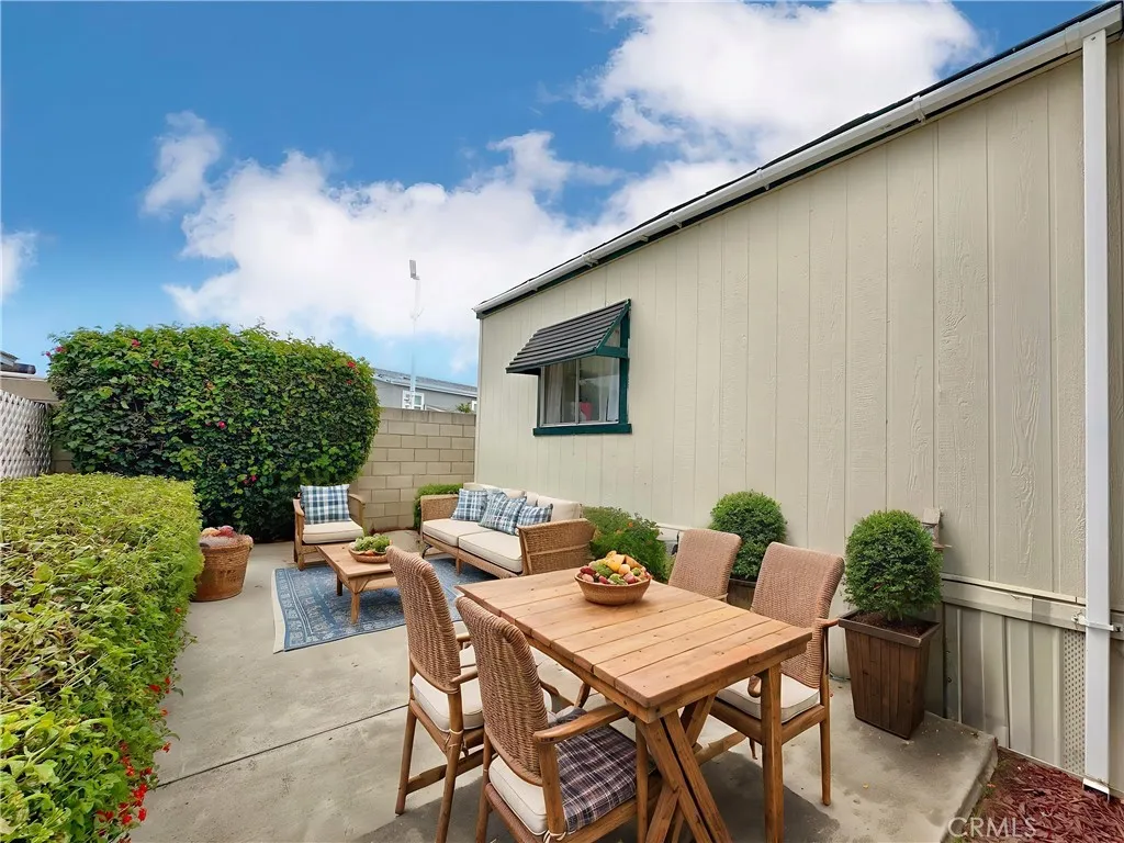 692 North Adele Street, Unit 30 Orange, CA 92867 - Photo 20 of 20 a backyard of a house with dining table and chairs with plants