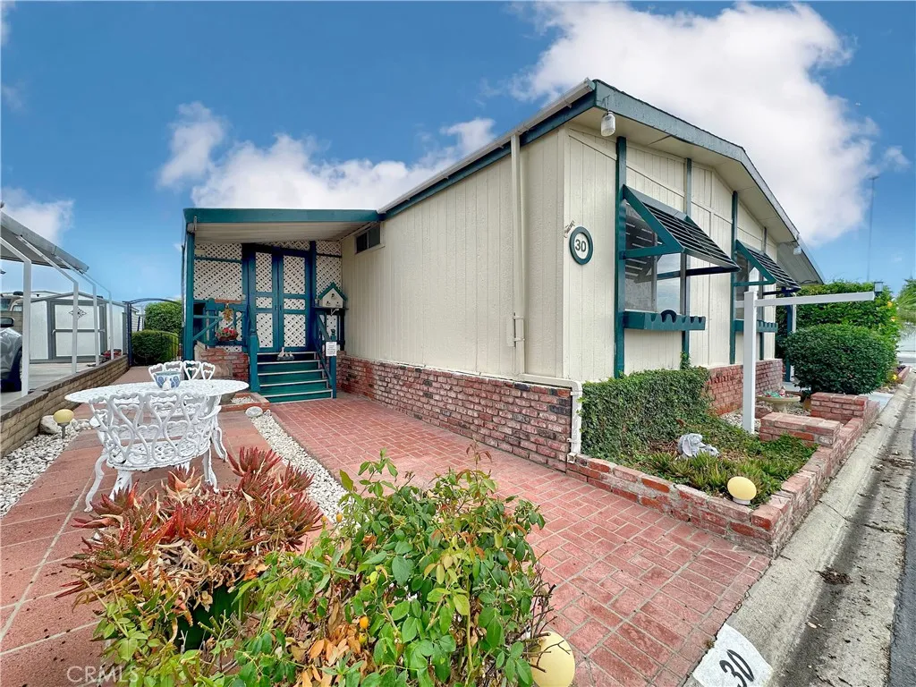 692 North Adele Street, Unit 30 Orange, CA 92867 - Photo 3 of 20 a front view of a house with garden