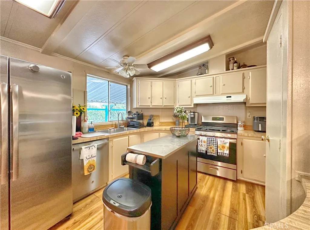 692 North Adele Street, Unit 30 Orange, CA 92867 - Photo 7 of 20 a kitchen with a sink a stove cabinets and stainless steel appliances