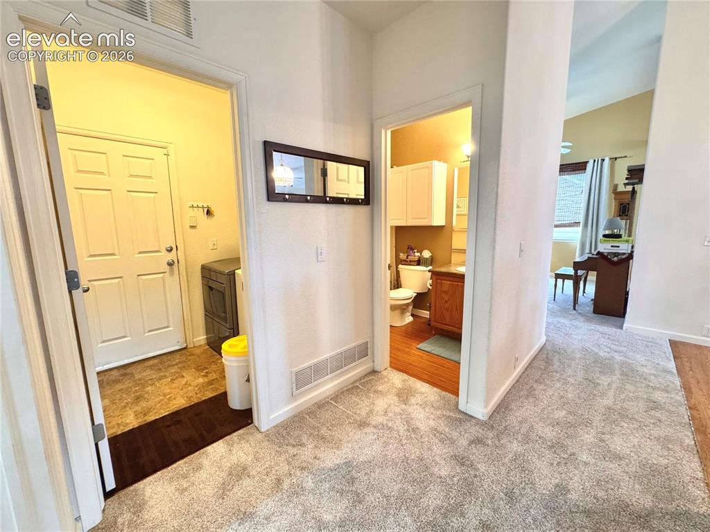 9362 St.George Road Peyton, CO 80831 - Photo 11 of 32 a view of a hallway with furniture and a livingroom