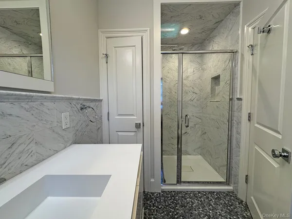a bathroom with a shower and a sink