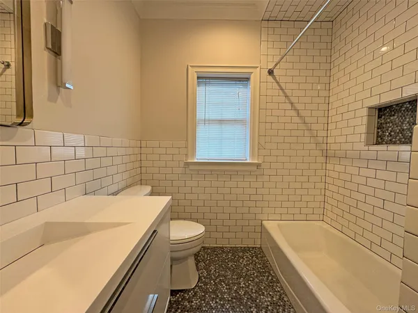 a bathroom with a sink a toilet and bathtub