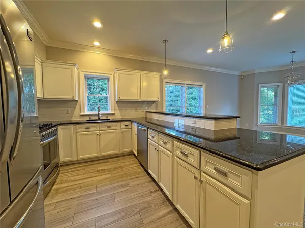a kitchen with granite countertop white cabinets and white appliances
