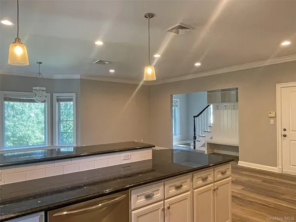 a kitchen with granite countertop cabinets and window