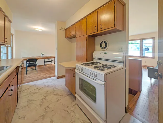 a kitchen with stainless steel appliances granite countertop a sink stove and cabinets
