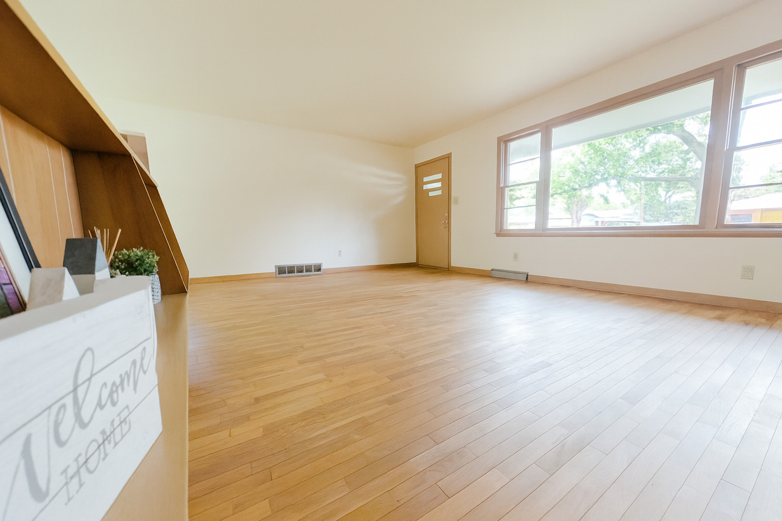 1 Gary Court Normal, IL 61761 - Photo 8 of 29 a view of an empty room with wooden floor and a window