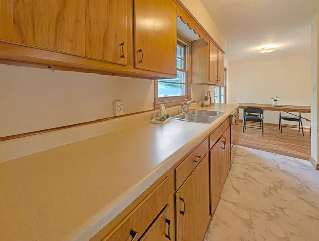 a kitchen with cabinets and a stove top oven