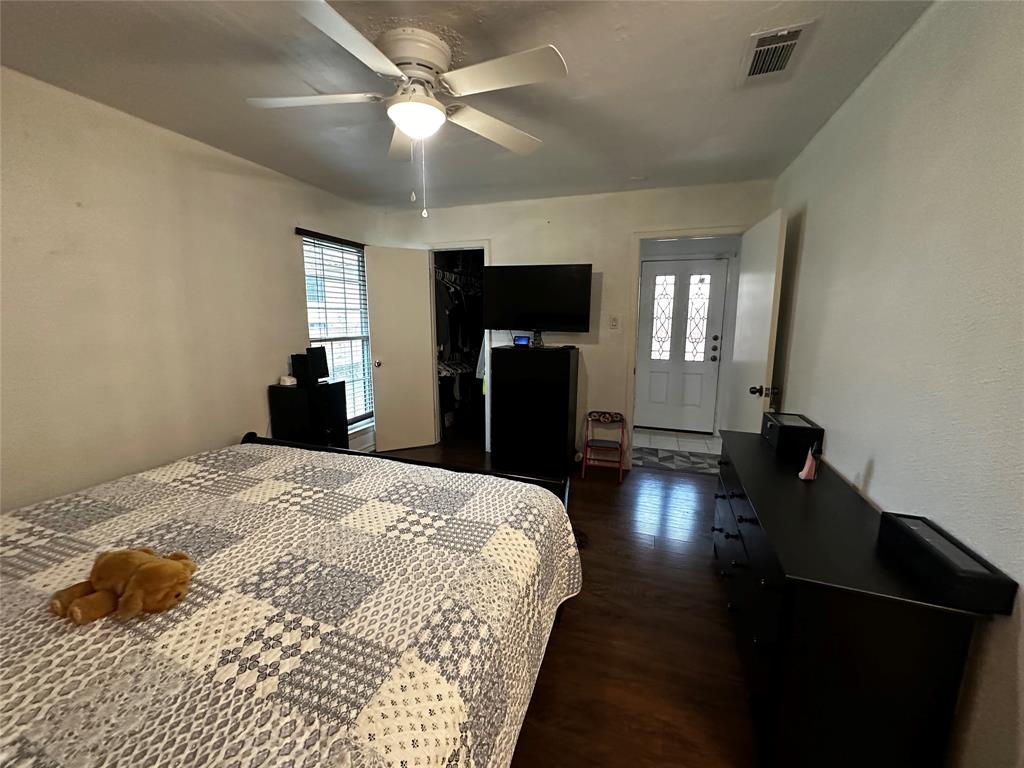 4272 Madera Road, Unit 4 Irving, TX 75038 - Photo 12 of 32 a spacious bedroom with a bed and a chandelier
