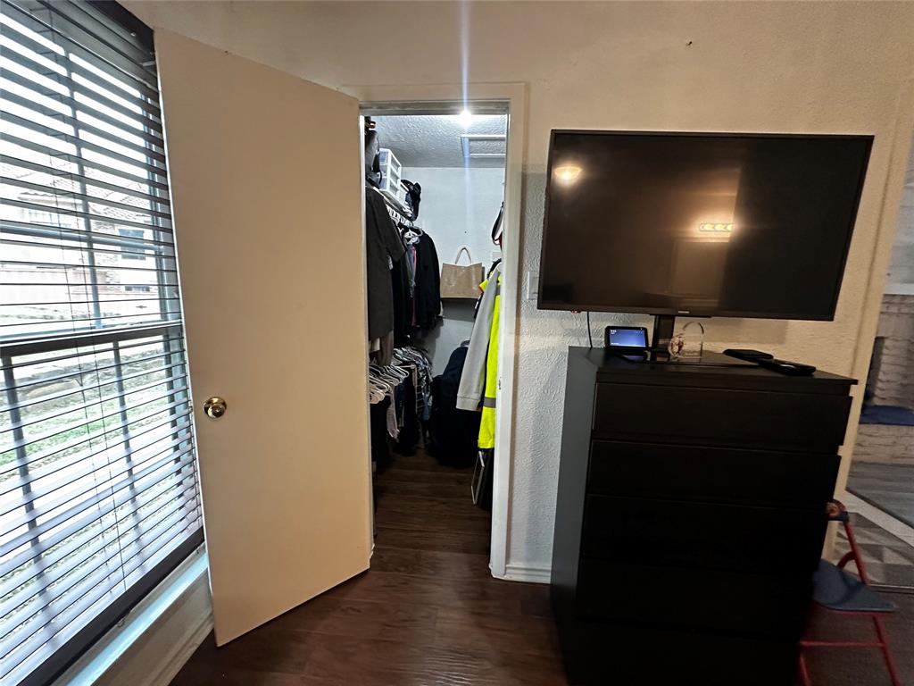 4272 Madera Road, Unit 4 Irving, TX 75038 - Photo 13 of 32 a view of a living room with a flat screen tv and floor to ceiling window