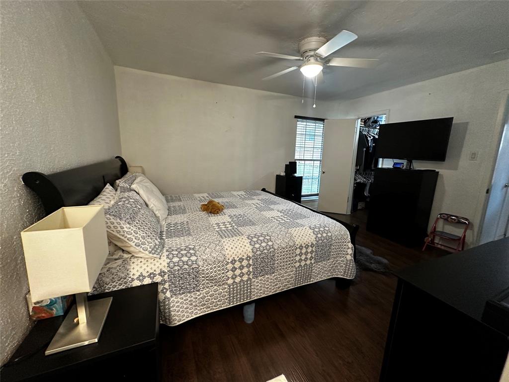 4272 Madera Road, Unit 4 Irving, TX 75038 - Photo 15 of 32 a bedroom with a bed and a flat tv screen on the dresser