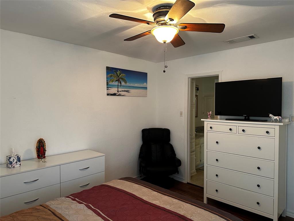 4272 Madera Road, Unit 4 Irving, TX 75038 - Photo 20 of 32 a bedroom with a bed and a flat tv screen on the dresser
