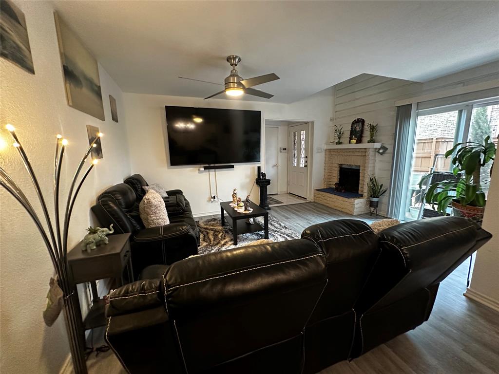 4272 Madera Road, Unit 4 Irving, TX 75038 - Photo 24 of 32 a living room with furniture a flat screen tv and a fireplace