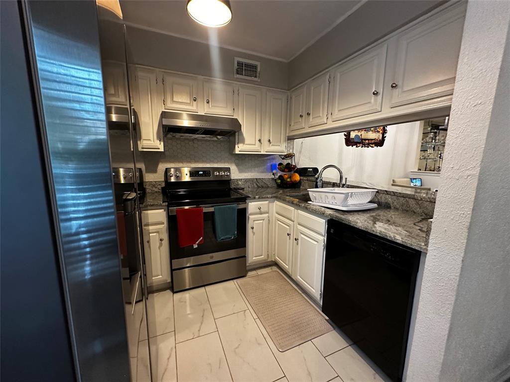 4272 Madera Road, Unit 4 Irving, TX 75038 - Photo 26 of 32 a kitchen with stainless steel appliances granite countertop a stove a sink and a refrigerator