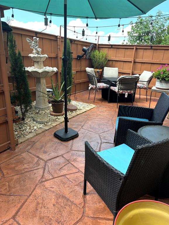 4272 Madera Road, Unit 4 Irving, TX 75038 - Photo 29 of 32 a view of a patio with table and chairs under an umbrella