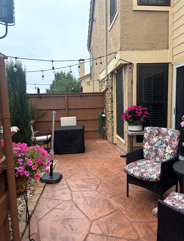 4272 Madera Road, Unit 4 Irving, TX 75038 - Photo 31 of 32 a view of a chairs and table in the back yard of the house
