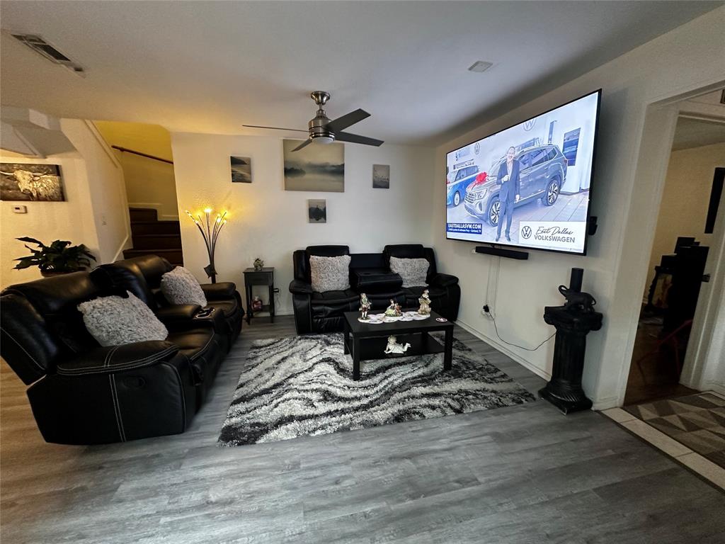 4272 Madera Road, Unit 4 Irving, TX 75038 - Photo 6 of 32 a living room with furniture a flat screen tv and wooden floor